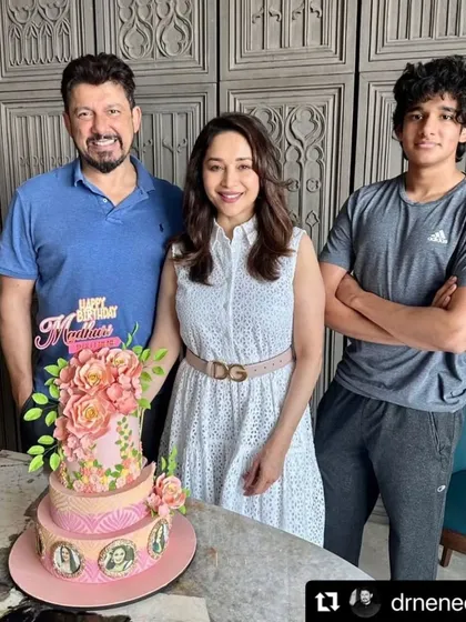 It was an absolute delight to create this three-tiered floral masterpiece for the iconic Madhuri Dixit Nene's birthday, seen here with her family. The cake features edible photos from her films and is adorned with beautiful sugar flowers.