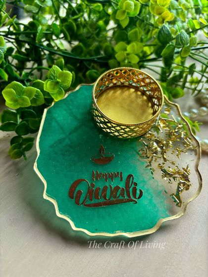 A vibrant green "Happy Diwali" tea light holder. These pieces are handcrafted to bring charm and a warm glow to your festival of lights.