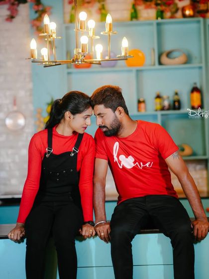 An intimate, forehead-to-forehead moment in the kitchen set.