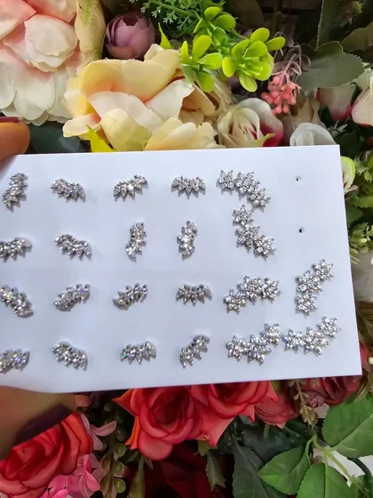 A collection of our marquise-cut leaf and crown-shaped studs, offering a unique and sophisticated look.