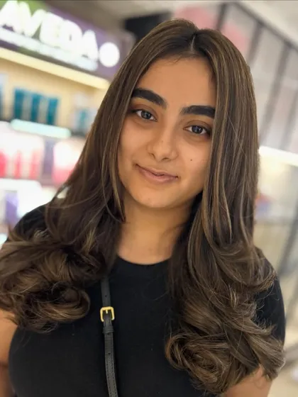 A classic back-to-back foiling technique creates these beautiful cool-tone highlights. The layers are shaped to frame the face, adding softness to the look.