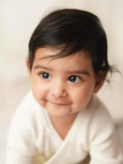A close-up of the baby's cheeky grin. His personality is already shining through in this adorable portrait.