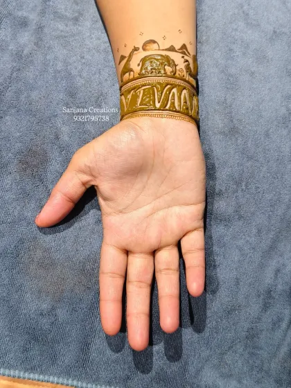 The back of the hand, showing the jungle safari wristband with elephants under the sun. A simple yet beautiful continuation of the baby shower theme.