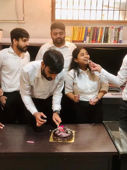 Sharing a piece of birthday cake with a team member. It's these small, personal interactions that build a strong and supportive professional family.