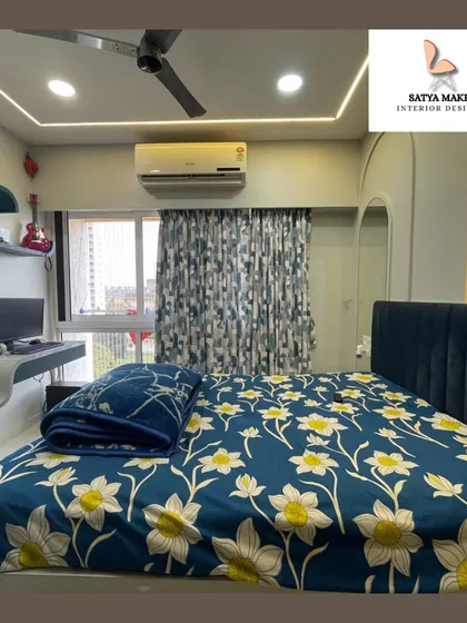 This image highlights the cozy corner with the bed and the functional study area by the window.