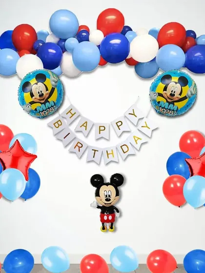 A simple and classic Mickey Mouse themed birthday setup with a balloon garland and character foils.