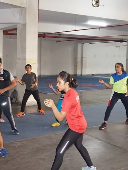 Students engage in footwork exercises without their weapons. Mastering movement is the first step to mastering the sport, and we dedicate significant time to these fundamentals.
