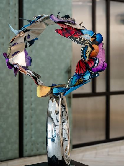 A side view of "Flight to Infinity," demonstrating its elegant, circular form and the sense of perpetual motion it creates.