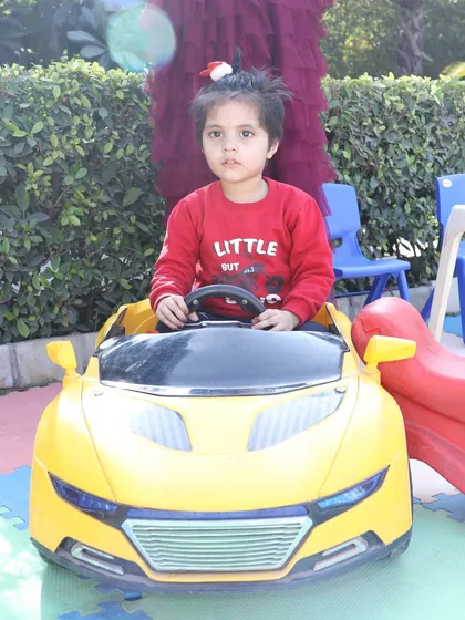 Another shot of the little girl in the toy car, showing how much fun toddlers have in the play zones I create.