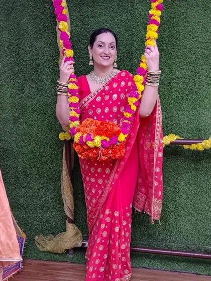 One of our members enjoying the decorated swing during our Teej festivities.