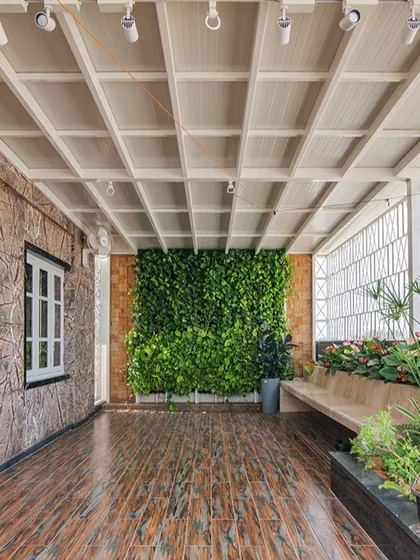 The penthouse terrace is a green oasis in the city, with a vertical garden, built-in seating, and lush planters creating a perfect space for relaxation and yoga.