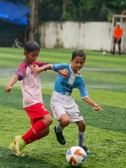 A classic one-on-one battle for the ball, showcasing the competitive spirit and determination of our U11 players.