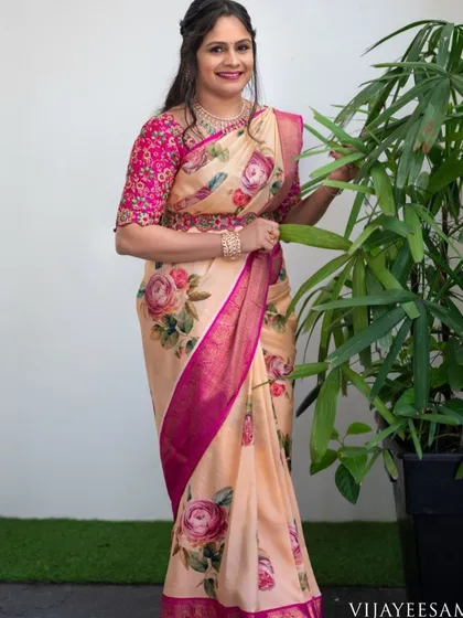 The final look is pure elegance. The client wears a floral print saree with a custom-designed magenta blouse, featuring detailed embroidery on the sleeves and a matching embroidered belt.