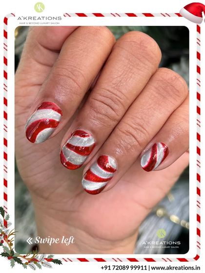 Another angle of the festive red and silver candy cane striped nail art, showing the glossy, high-shine finish.