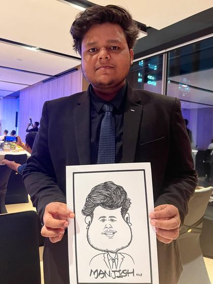 A guest in a suit holding his caricature at a formal corporate dinner. Our service fits in perfectly, from casual exhibitions to formal functions.