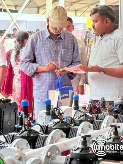 A visitor closely inspecting our range of automated valves at Krishi Mela.