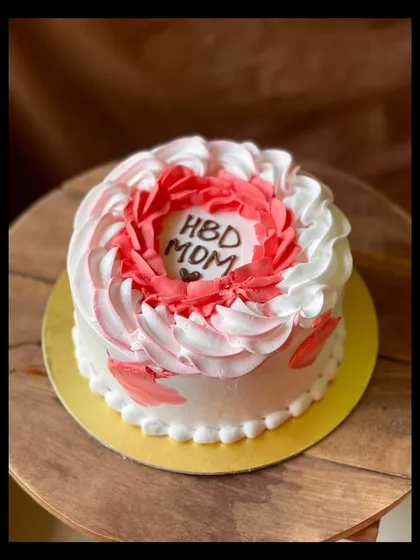 A simple and sweet birthday cake for a mom, with red and white buttercream swirls.