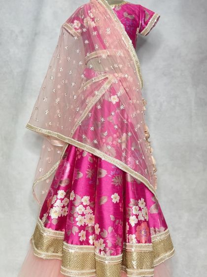 A full view of the in-house printed floral lehenga, showing how the soft net dupatta and layered skirt create a dreamy, romantic effect.
