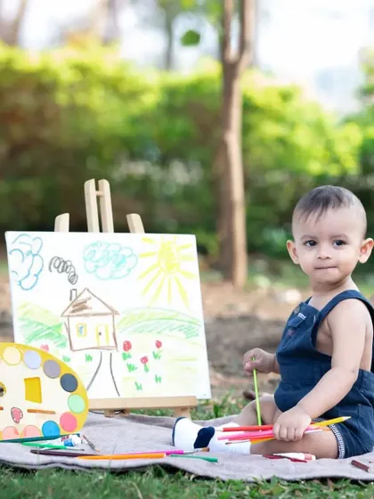 This one-year-old artist is ready to paint a masterpiece.