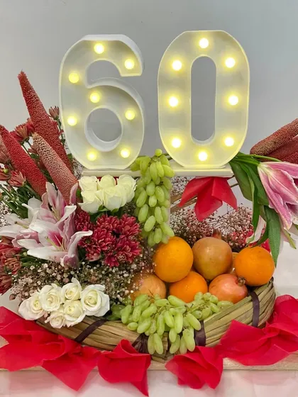 A perfect summer hamper for a wonderful couple on their 60th anniversary. This basket combines fresh fruits with beautiful flowers and light-up '60' numbers.