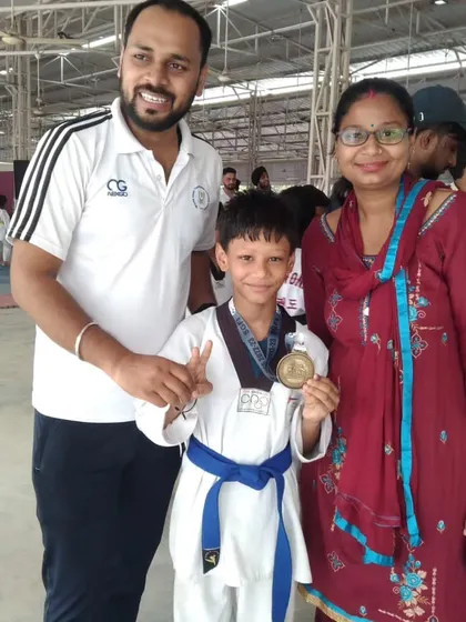 A young blue belt student celebrating his gold medal win at the 4th National Sikh Games.