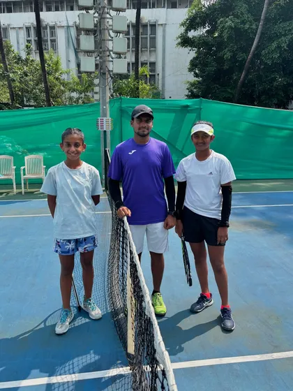 Our coach with two promising young players at the Inter School Tennis Tournament 2024. Mentorship is a key part of our philosophy.