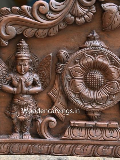 A detail of Garuda, the eagle mount of Lord Vishnu, carved with folded hands in reverence on the Narayanar panel.