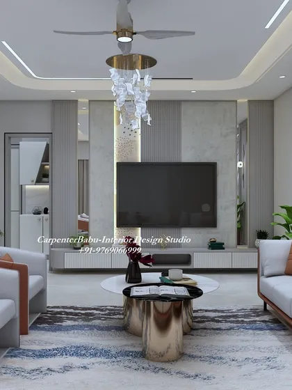 A living room in Panvel with a dramatic, backlit 3D wall feature. The orange and grey color scheme of the furniture creates a bold and contemporary look.