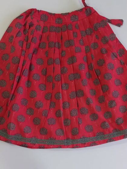 This is the skirt of my Taara Set. It's a simple yet beautiful block-printed cotton ghagra with a crochet lace border. The adjustable waist tie ensures a perfect fit as your child grows.
