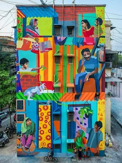 This vibrant, multi-story mural titled "Me/We" captures the spirit of community in Mumbai. It's a colorful depiction of daily life, showing different families and individuals coexisting in a single building, a true reflection of the city's soul.