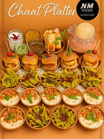 A tribute to Mumbai's vibrant street food scene. This chaat platter features gourmet versions of classics like Pao Bhaji Fondue, Palak Patta Chaat, and mini Vada Pavs, all beautifully arranged and packed with flavor.