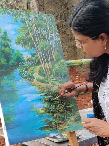 Adding the final touches to the water lilies in my painting of the Lalbagh lake.