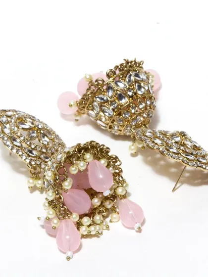 Our kundan jhumkas are a popular choice for summer weddings. This pink version is both festive and elegant, and like all our pieces, can be customized.