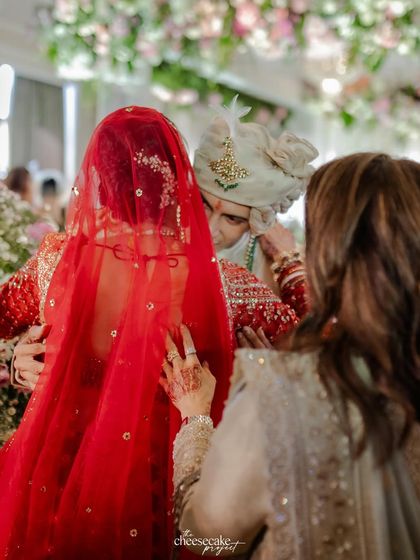 A mother's hand on her son's shoulder, a quiet moment of support and love during the ceremony.