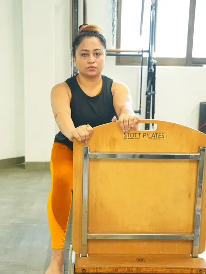 Using the Pilates chair, this client works on her form and alignment. The chair is a versatile piece of equipment that can be used for a wide range of strengthening and conditioning exercises.