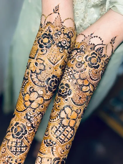 A creative pose showing off the beautiful details of Rumana's mehendi. The mix of dark and light shading is stunning.