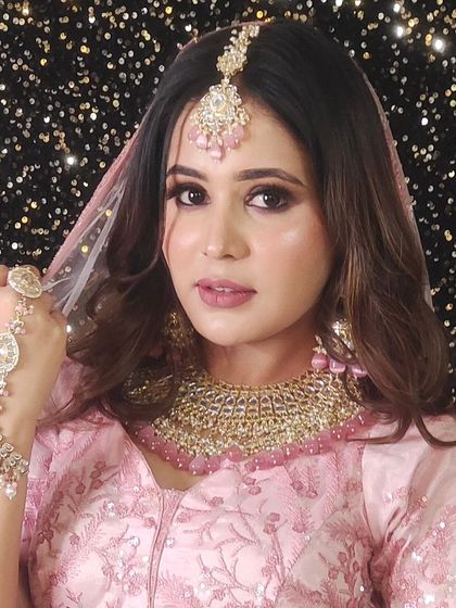 Another angle of the pink lehenga look, showing the beautiful hathphool and jewellery details.