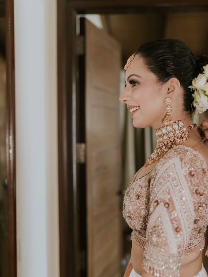 A happy, candid moment. The makeup is light and fresh, perfect for a daytime wedding ceremony in a beautiful location.