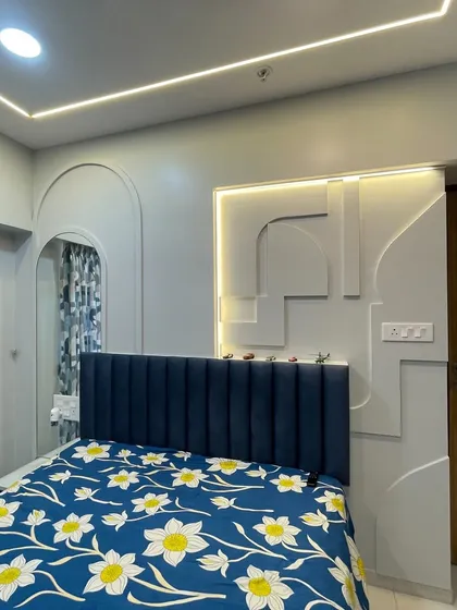This kids' room features a cool blue and white palette with modern geometric wall paneling and an arched mirror, creating a stylish and contemporary vibe.