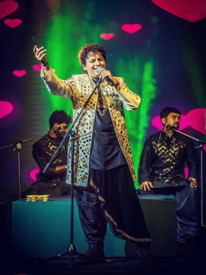 A stunning shot of our lead vocalist at a grand event, with a backdrop of hearts.