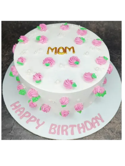 A simple floral cake for Mom's birthday. This mixed fruit cake is decorated with pretty pink rosettes.