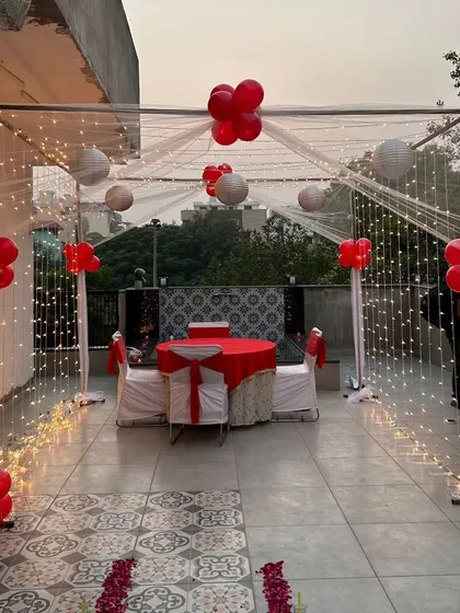 I can transform any terrace into a private dining escape. This classic romantic dinner setup features a structured cabana draped with sheer fabric and twinkling fairy lights, creating the perfect intimate setting for an anniversary or special date night.