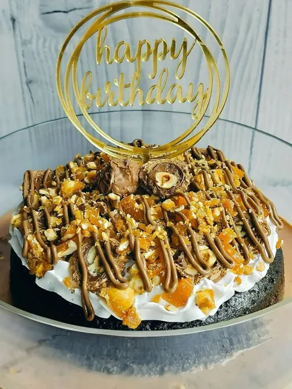 This angle showcases the generous toppings and the rich, milk-soaked base of the Choco Rocher Tres Leches, promising a truly satisfying dessert experience.