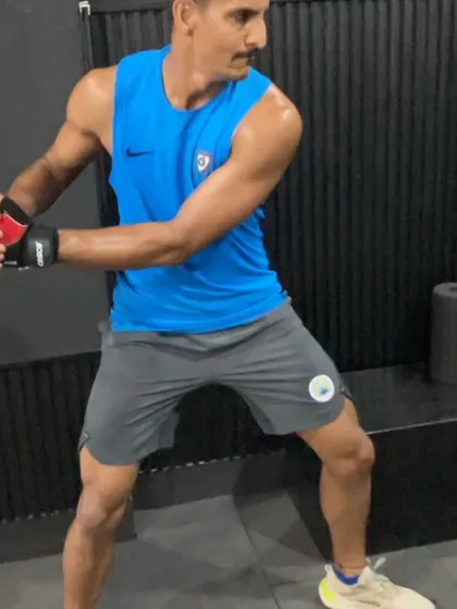 A cricket all-rounder performing a banded rotational pull, a key exercise in his pre-season strength and power development program.