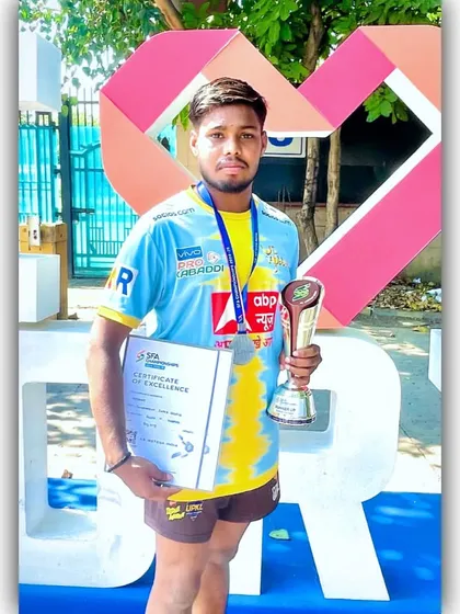 An academy player with his certificate of excellence and 2nd place trophy from the SFA U-19 tournament.
