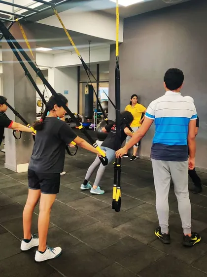 Our athletes engage in a TRX suspension training session at the gym. This full-body workout builds the core strength and endurance necessary for peak performance.