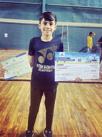 One of my promising young players with his winner's certificate and prize from a local tournament. We nurture talent from the very beginning of their competitive journey.