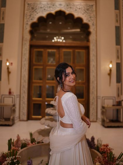 A playful over-the-shoulder smile. The back of this blouse has beautiful, delicate detailing.