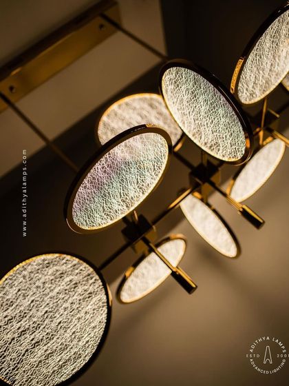 This artistic chandelier is composed of multiple circular discs with a unique woven texture. The layered arrangement and soft backlighting create a beautiful interplay of light and shadow, making it a captivating centerpiece.