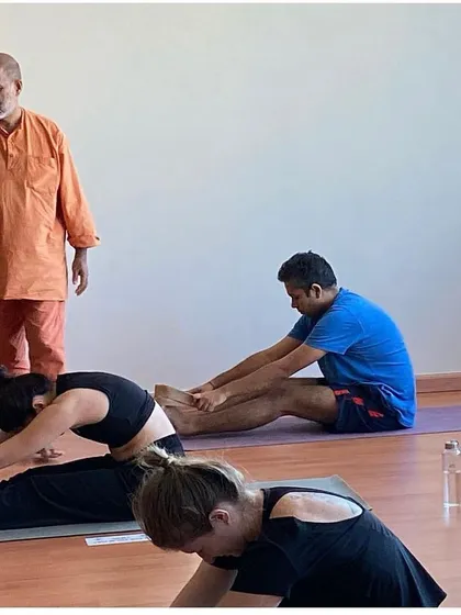 During a masterclass in Dubai, I observe and guide students in their forward bends. My focus is always on teaching the authentic principles of Hatha yoga for physical health and mental peace.